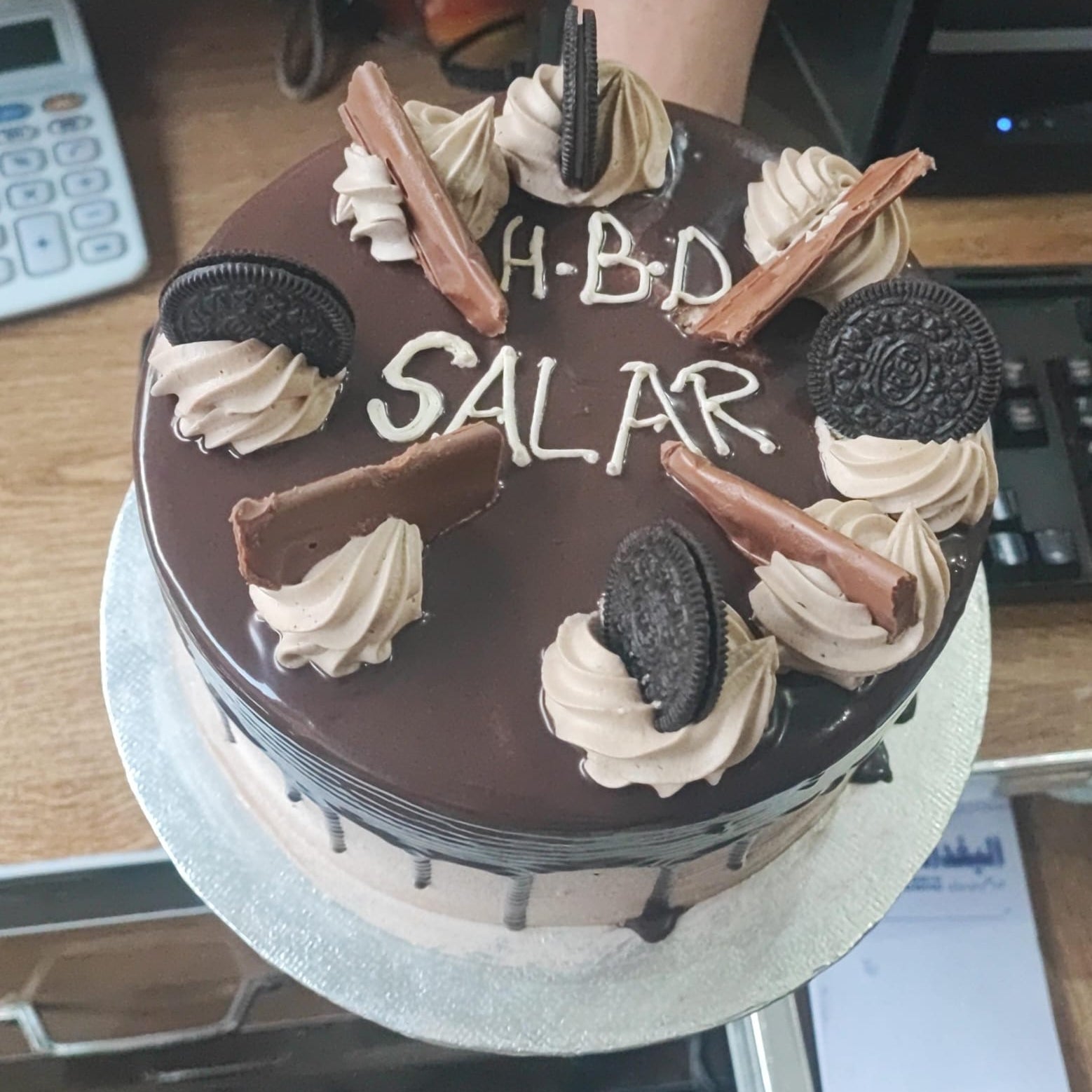 Chocolate birthday cake with whipped cream, cookies,